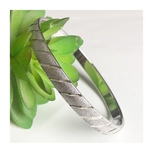 MONET Textured Silver Tone Bangle Bracelet with Stripe Detail